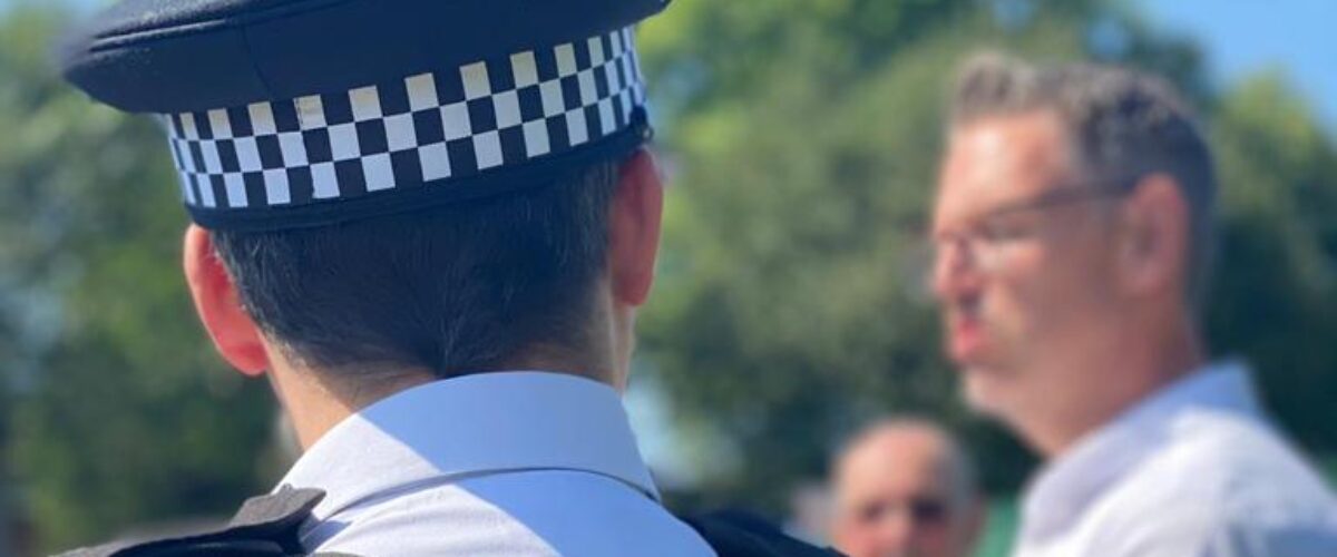A photo of PCC John Campion talking to a police officer