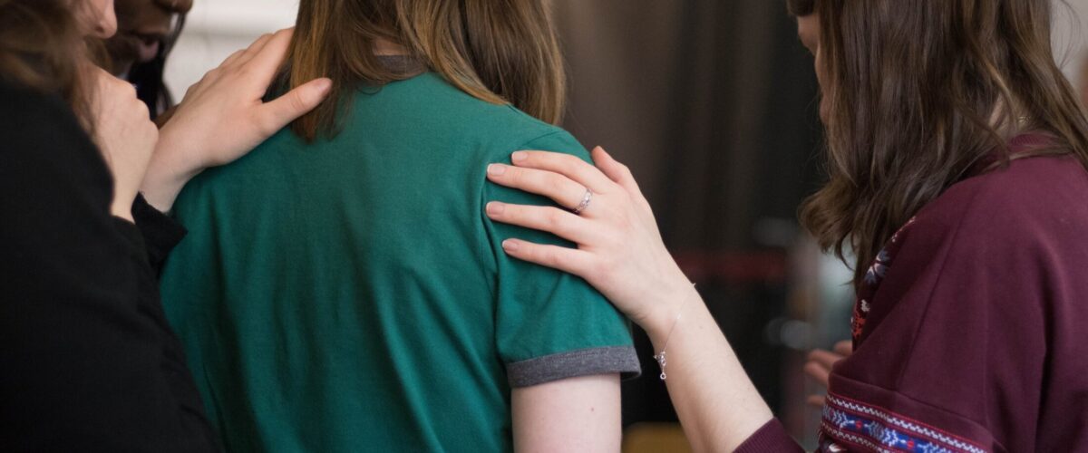 Stock image of a women putting her hand on someone's shoulder