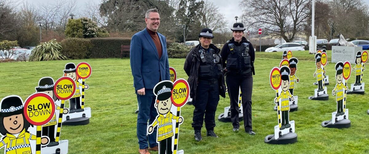 PCC John Campion with Constable Natalie Baggot and Detective Constable Sian Evans stood next to mini police officers