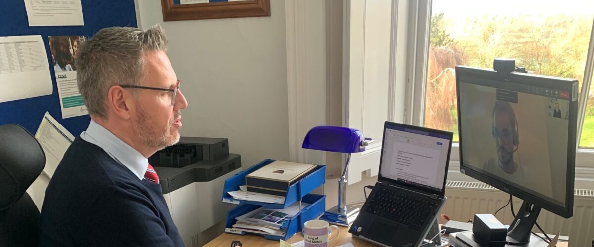 PCC John Campion looking at the computer as he takes part in a virtual meeting
