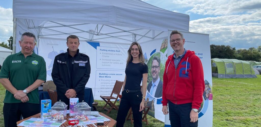 PCC John Campion joined by 3 people, stood outside a gazebo at a summer event